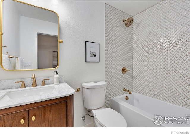 full bathroom featuring washtub / shower combination, vanity, and toilet