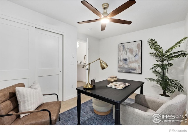 office area with light hardwood / wood-style floors and ceiling fan