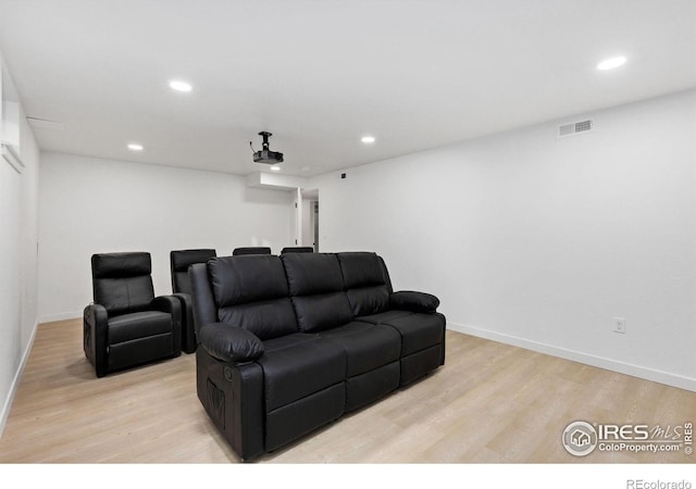 cinema featuring light hardwood / wood-style flooring