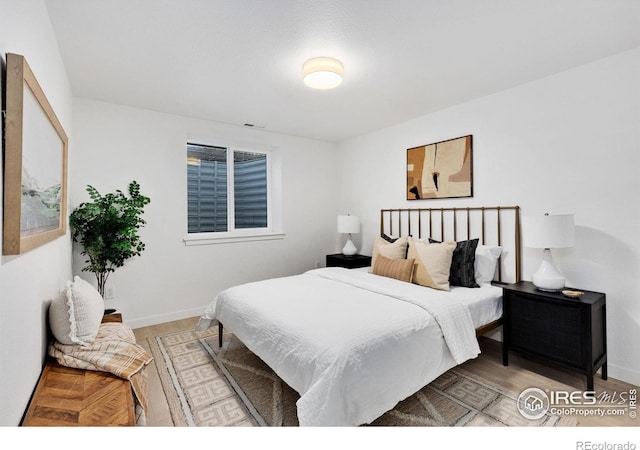 bedroom with wood-type flooring