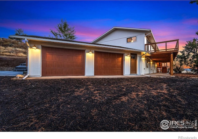 view of front of house featuring a garage and a balcony