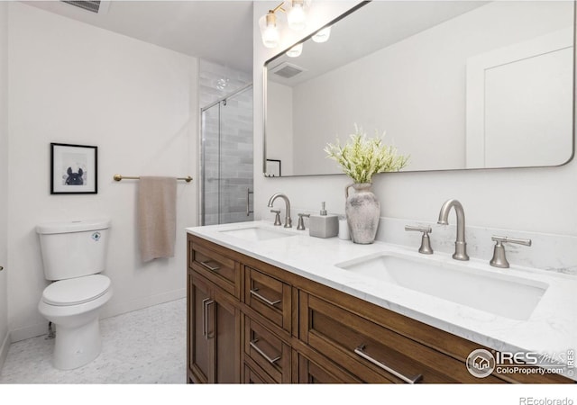 bathroom with vanity, toilet, and walk in shower