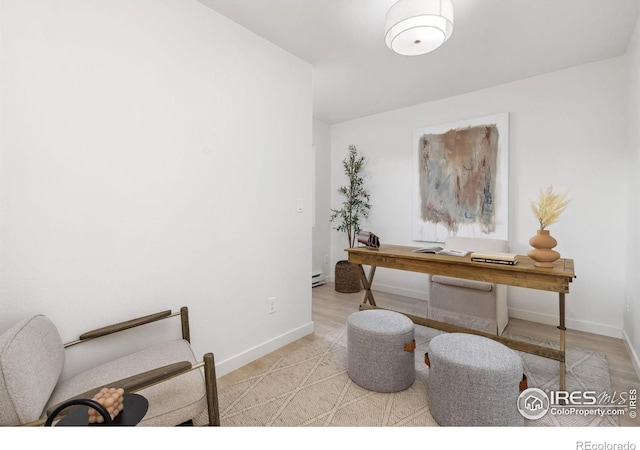 home office with light hardwood / wood-style floors