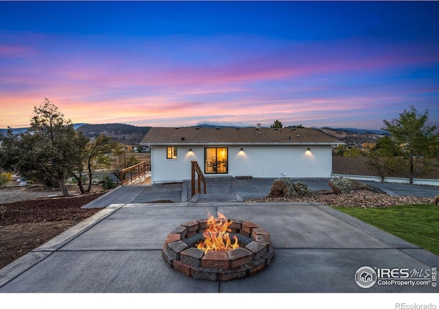 view of front of house featuring a fire pit and a patio