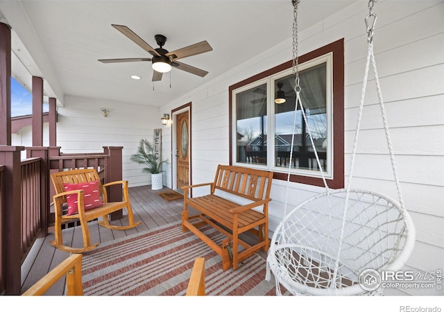 wooden terrace featuring a porch and ceiling fan