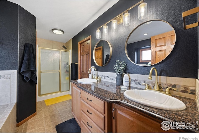 bathroom featuring walk in shower, tile patterned floors, and vanity