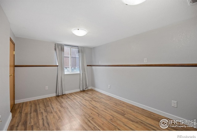 unfurnished room featuring hardwood / wood-style floors