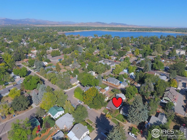 birds eye view of property with a water and mountain view