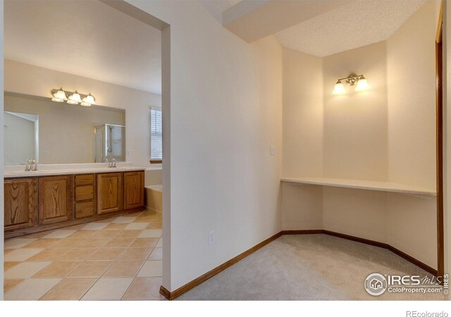 bathroom with tile patterned floors and vanity