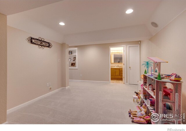 recreation room with light carpet and sink