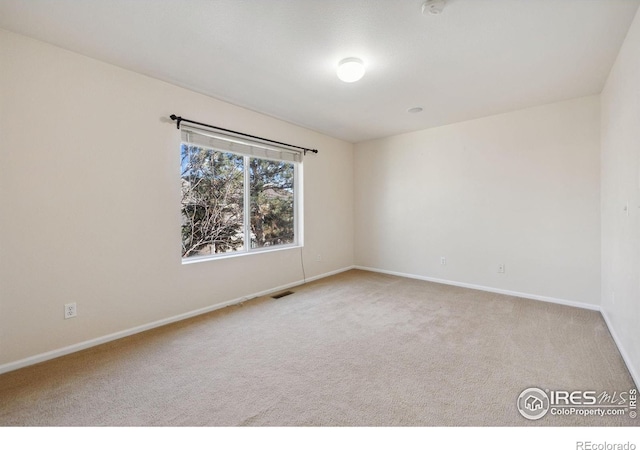 empty room featuring light carpet