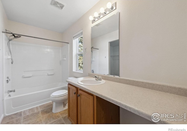 full bathroom with toilet, vanity, and  shower combination