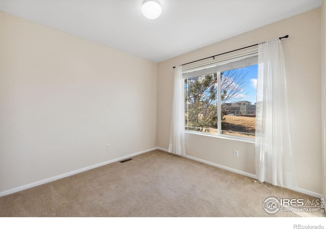 unfurnished room featuring light carpet