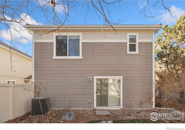 rear view of property featuring central air condition unit