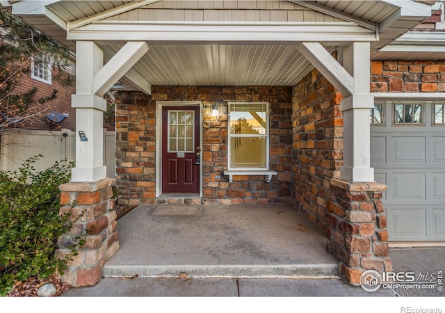 view of exterior entry featuring covered porch