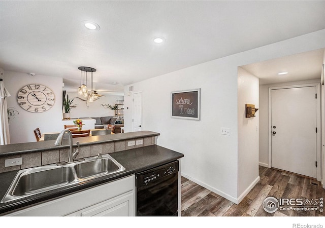 kitchen with dark hardwood / wood-style flooring, sink, decorative light fixtures, dishwasher, and white cabinetry