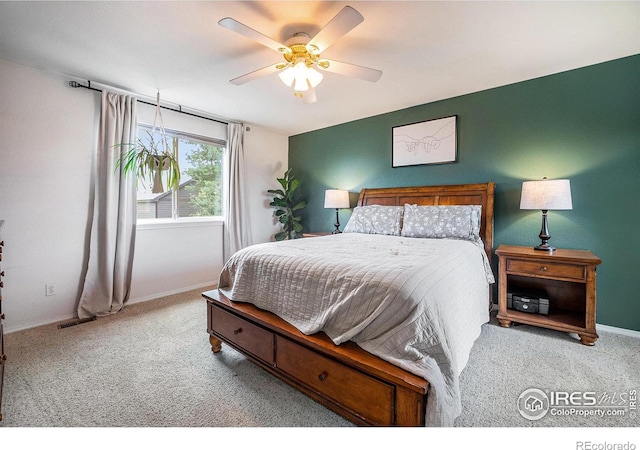 bedroom with ceiling fan and light colored carpet