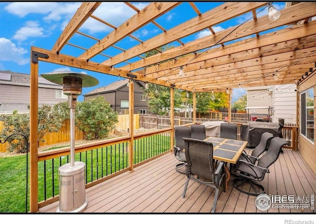 wooden deck featuring a pergola and a lawn