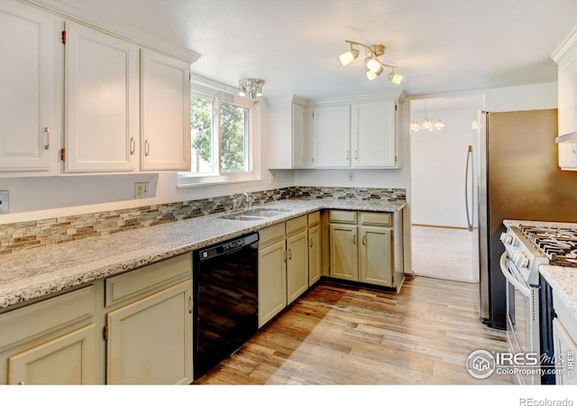 kitchen featuring light stone countertops, dishwasher, stainless steel range oven, and sink