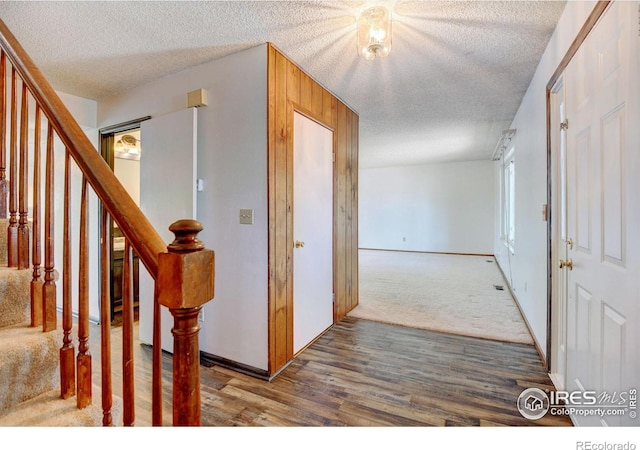 hallway with wood-type flooring and a textured ceiling