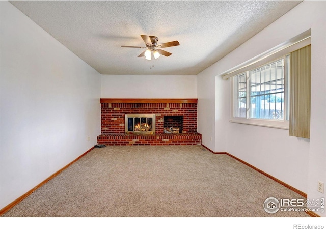 unfurnished living room with a fireplace, carpet, a textured ceiling, and ceiling fan