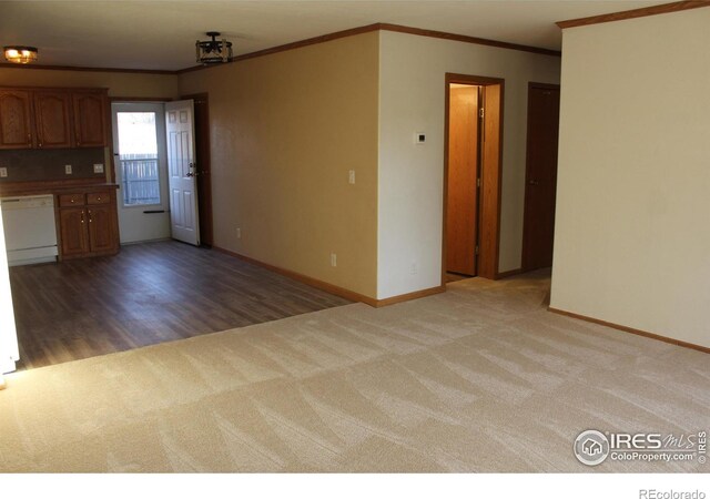 interior space with light carpet, baseboards, ornamental molding, dishwasher, and brown cabinetry