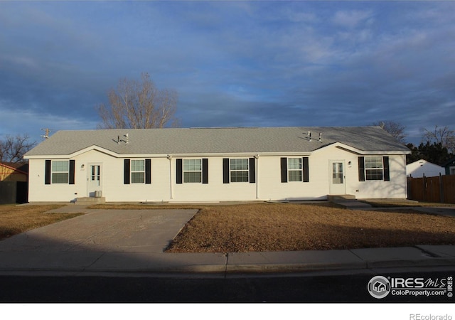 ranch-style home with fence