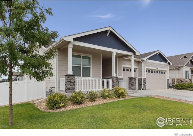 craftsman-style home with a front lawn, a porch, and a garage