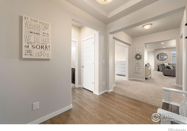 hallway with hardwood / wood-style floors