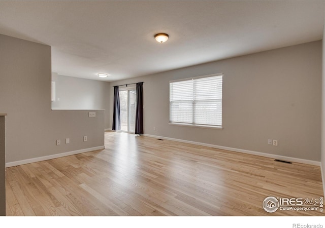 spare room featuring light wood-type flooring