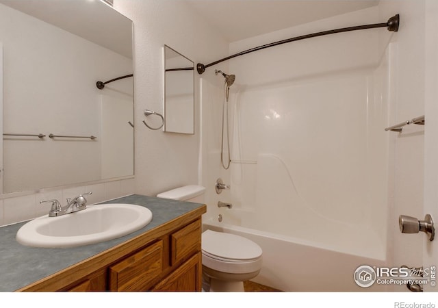 full bathroom featuring decorative backsplash, shower / tub combination, vanity, and toilet