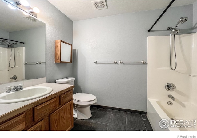 full bathroom featuring vanity, shower / bathing tub combination, a textured ceiling, and toilet