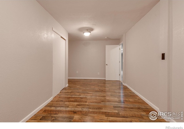 corridor with wood-type flooring