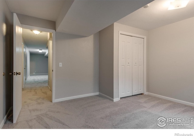 interior space with light carpet and a closet