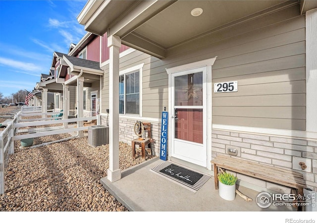 entrance to property with cooling unit and covered porch