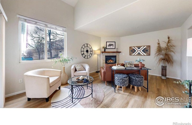 office with a tiled fireplace and light hardwood / wood-style flooring