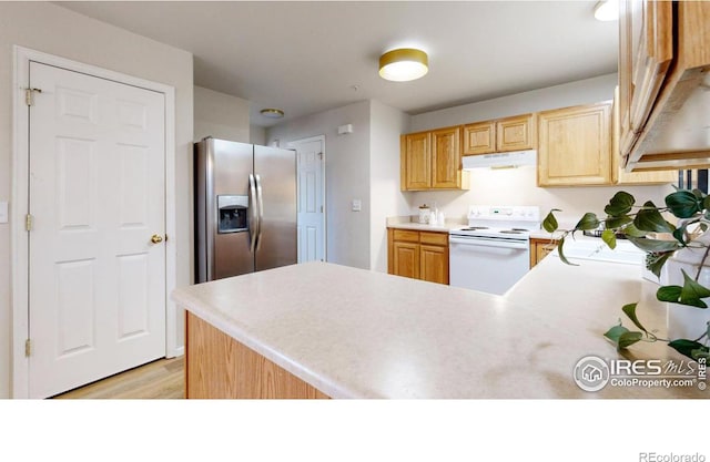 kitchen with white electric stove, stainless steel refrigerator with ice dispenser, light brown cabinets, and kitchen peninsula