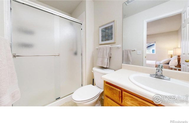 bathroom with walk in shower, vanity, and toilet