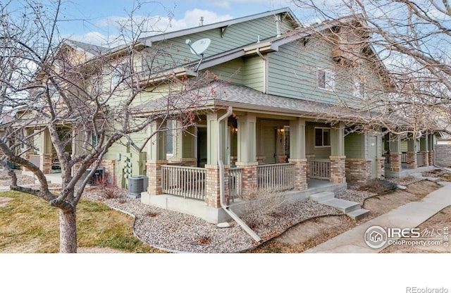 view of front facade with a porch and central AC unit