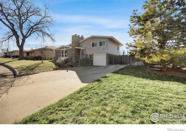 view of front of house featuring a front lawn and a garage