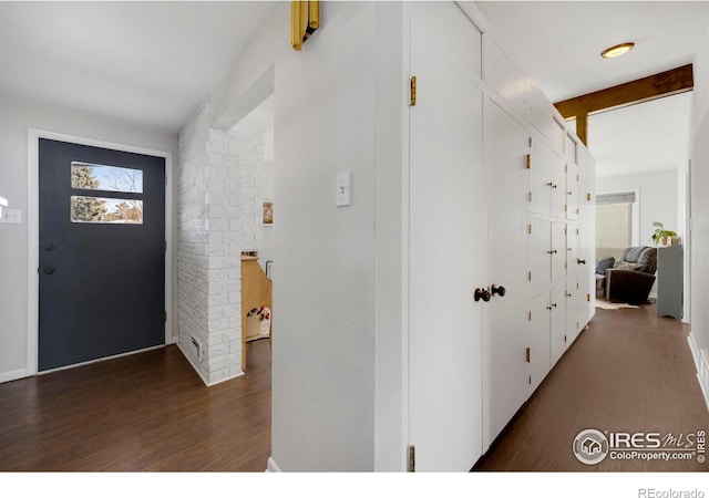 foyer entrance with beam ceiling and dark hardwood / wood-style flooring