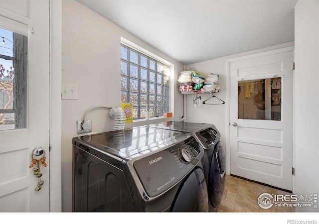 clothes washing area featuring independent washer and dryer