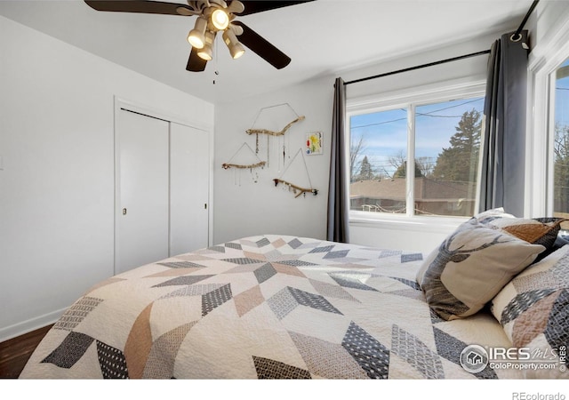 bedroom featuring hardwood / wood-style floors, ceiling fan, and a closet