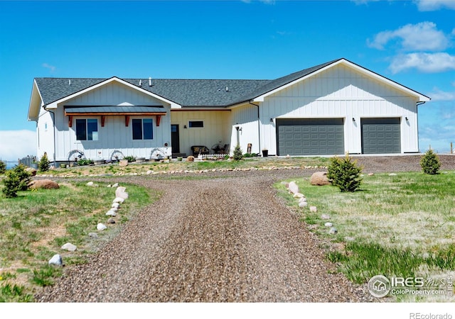 modern inspired farmhouse featuring a front yard and a garage