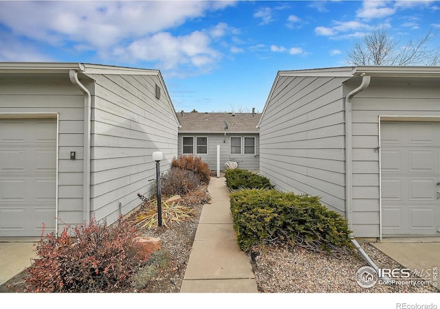 view of exterior entry with a garage