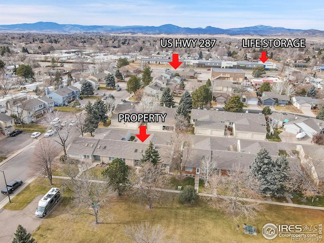 birds eye view of property featuring a mountain view