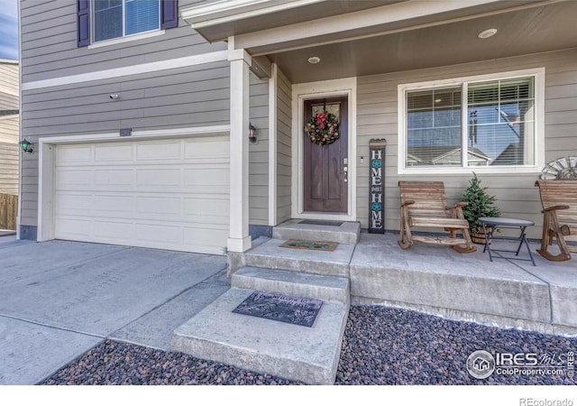 entrance to property with a porch and a garage