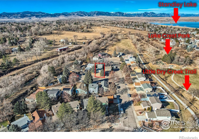 birds eye view of property with a water and mountain view