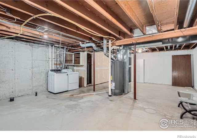 basement with washing machine and clothes dryer and water heater