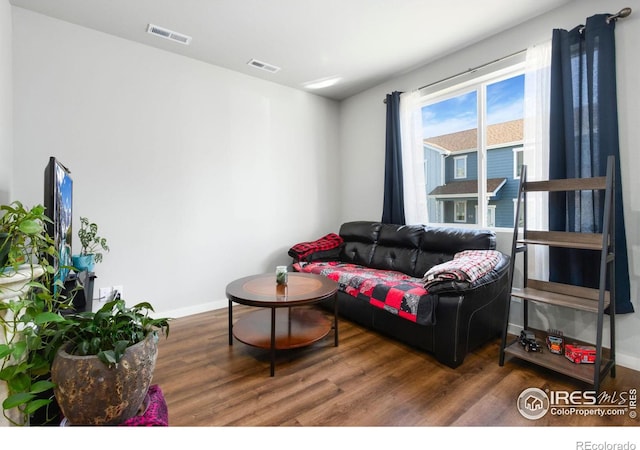 living room with dark hardwood / wood-style flooring